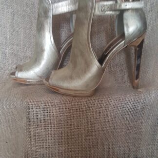 A pair of silver shoes sitting on top of a table.