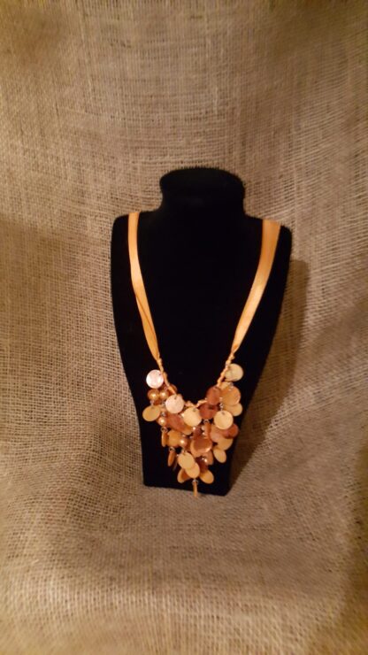 A necklace is shown on display in front of a black background.
