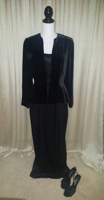 A black dress and jacket are on display.