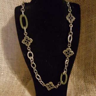 A necklace is shown on display in front of a black background.