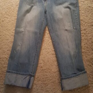 A pair of jeans that are on the floor.
