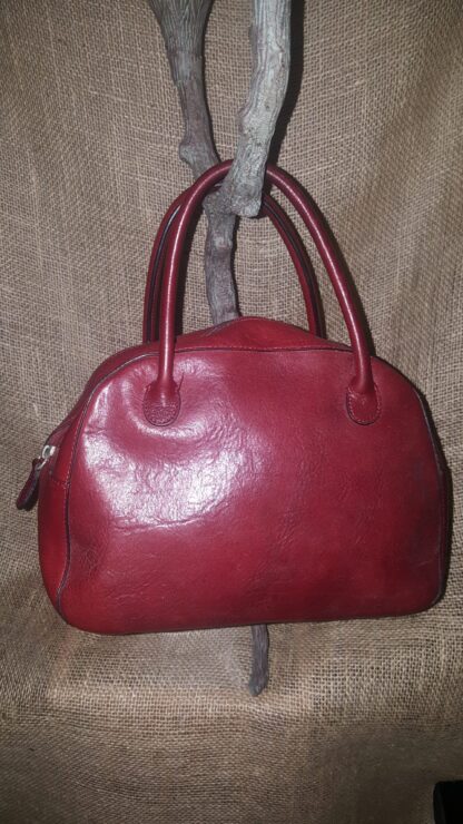 A red purse hanging on the wall