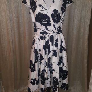 A dress that is on display in front of a curtain.