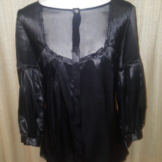 A black blouse with long sleeves and a tie.