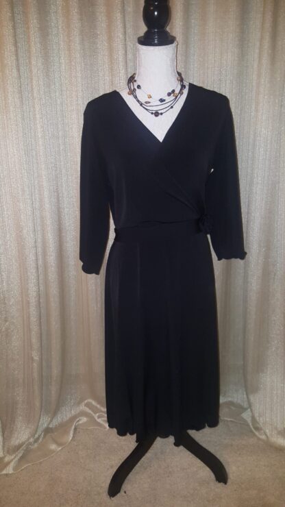 A black dress is shown with a white shirt.