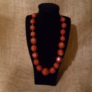 A necklace is displayed on the table.