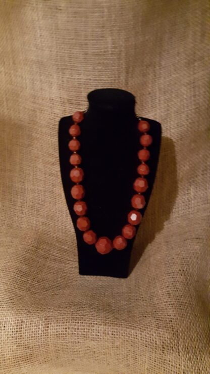 A necklace is displayed on the table.