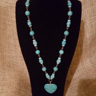 A necklace with a heart shaped pendant on it.