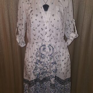 A dress that is on display in front of a curtain.