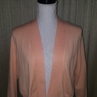 A pink cardigan is shown on display.