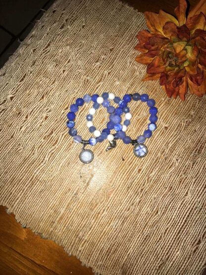 A pair of blue and white bracelets on top of a table.