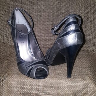 A pair of silver shoes sitting on top of a chair.