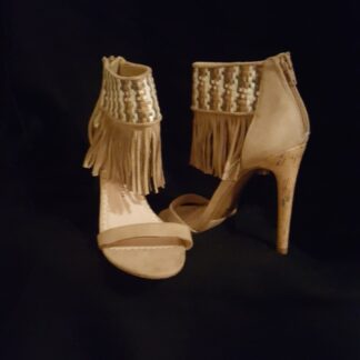 A pair of high heels with fringes on them.