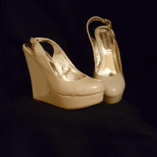 A pair of white shoes on top of a black background.