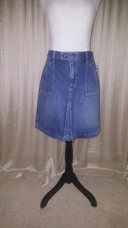 A blue skirt is on display in front of a white background.