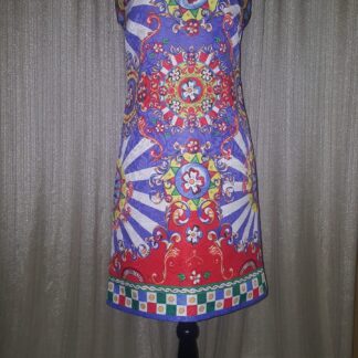A mannequin wearing a colorful dress with a pattern.