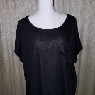 A black shirt is on display against the wall.