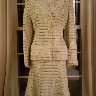 A suit that is on display in front of a window.