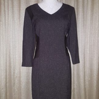 A dress that is on display against the wall.
