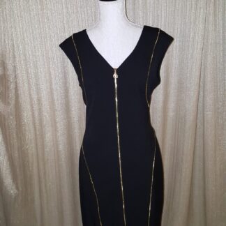 A black dress with gold zippers on it