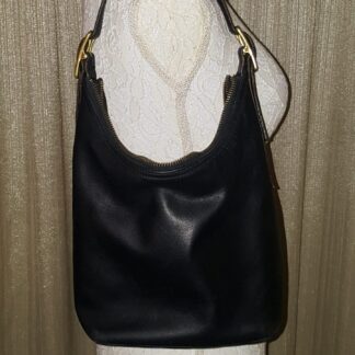 A black leather purse is shown on display.