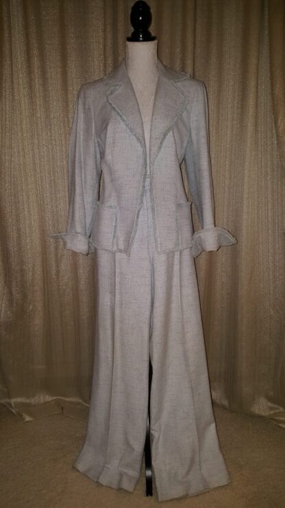 A white suit with long sleeves and a skirt.