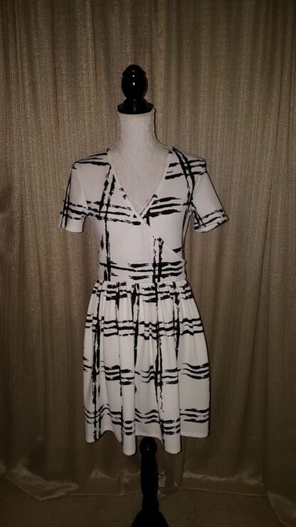 A dress that is on display in front of a curtain.