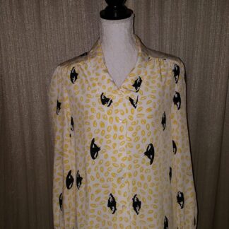 A yellow shirt with black and white birds on it