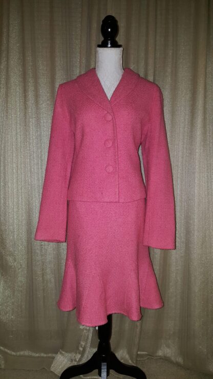 A pink suit is shown with a skirt.