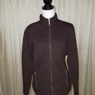 A brown jacket is on display against the wall.