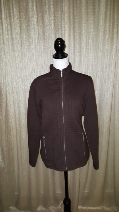 A brown jacket is on display against the wall.