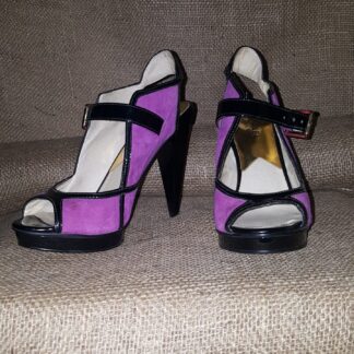 A pair of purple and black shoes on the stairs.