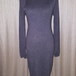 A dress that is on display against the wall.
