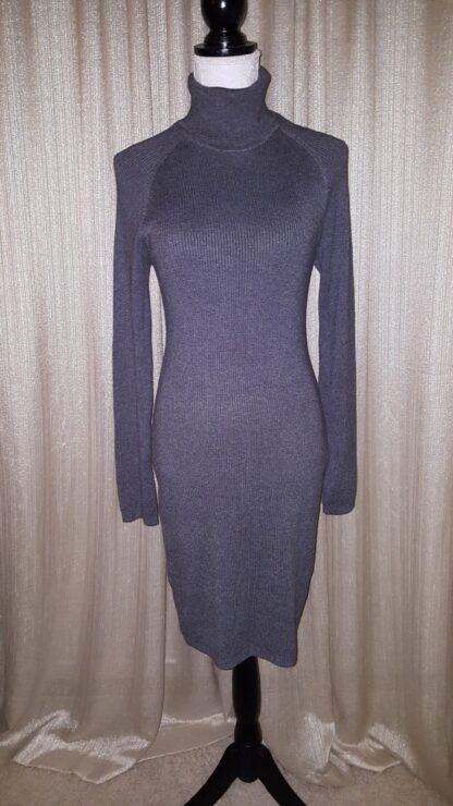 A dress that is on display against the wall.