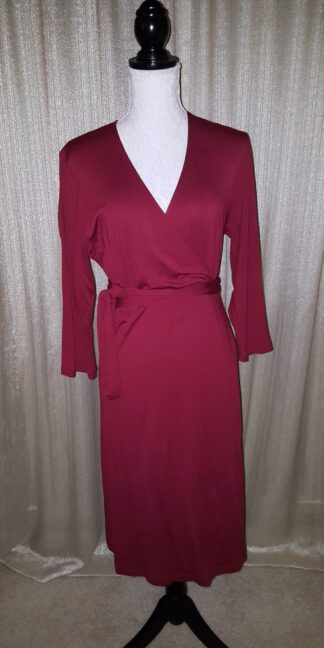 A red dress is shown on the mannequin.