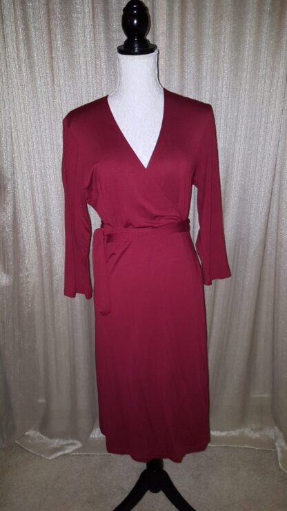A red dress is shown on the mannequin.
