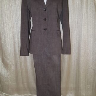 A long brown suit with three buttons and a white shirt.