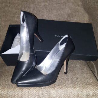 A pair of black shoes sitting on top of a box.