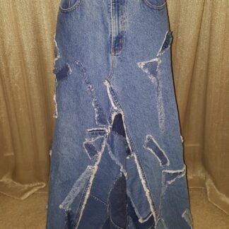 A long skirt made from jeans with designs on it.