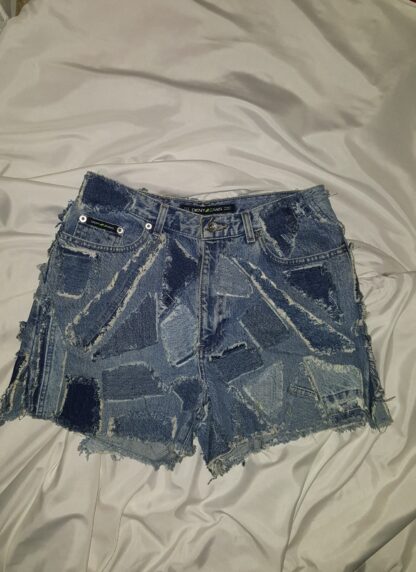 A pair of shorts that are on top of the bed.