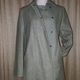 A coat is shown on display against the wall.