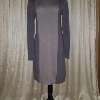 A dress that is on display against the wall.