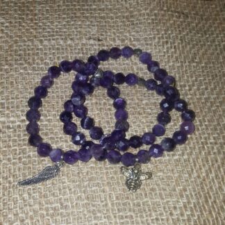 A purple bead necklace with a cross charm.