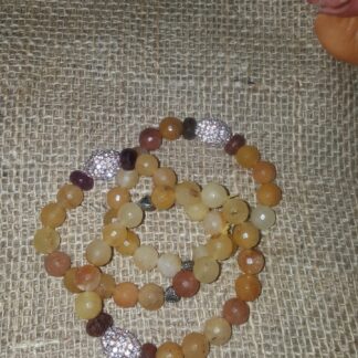 A bracelet that is laying on the ground.