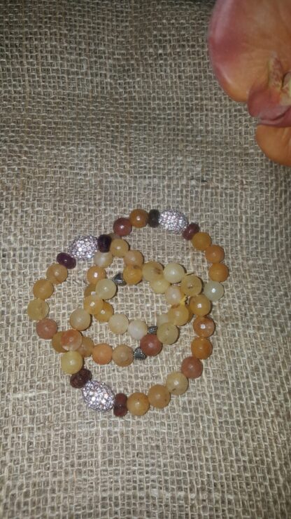 A bracelet that is laying on the ground.