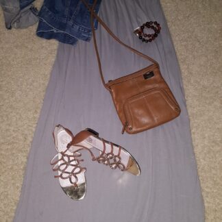 A purse and sandals are on the floor.