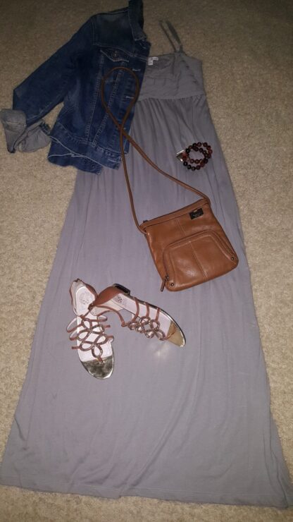 A purse and sandals are on the floor.