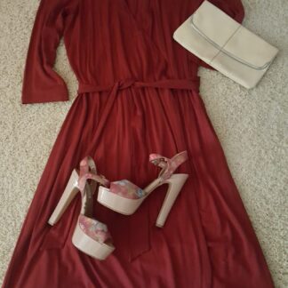 A red dress and white shoes on the floor