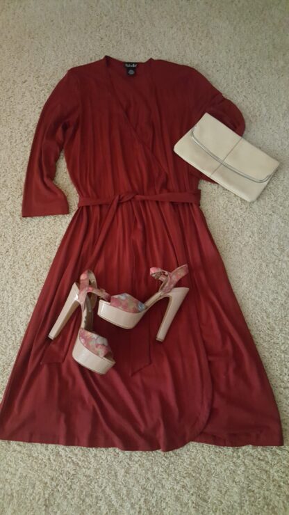 A red dress and white shoes on the floor