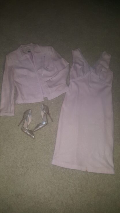 A white dress and jacket on the floor